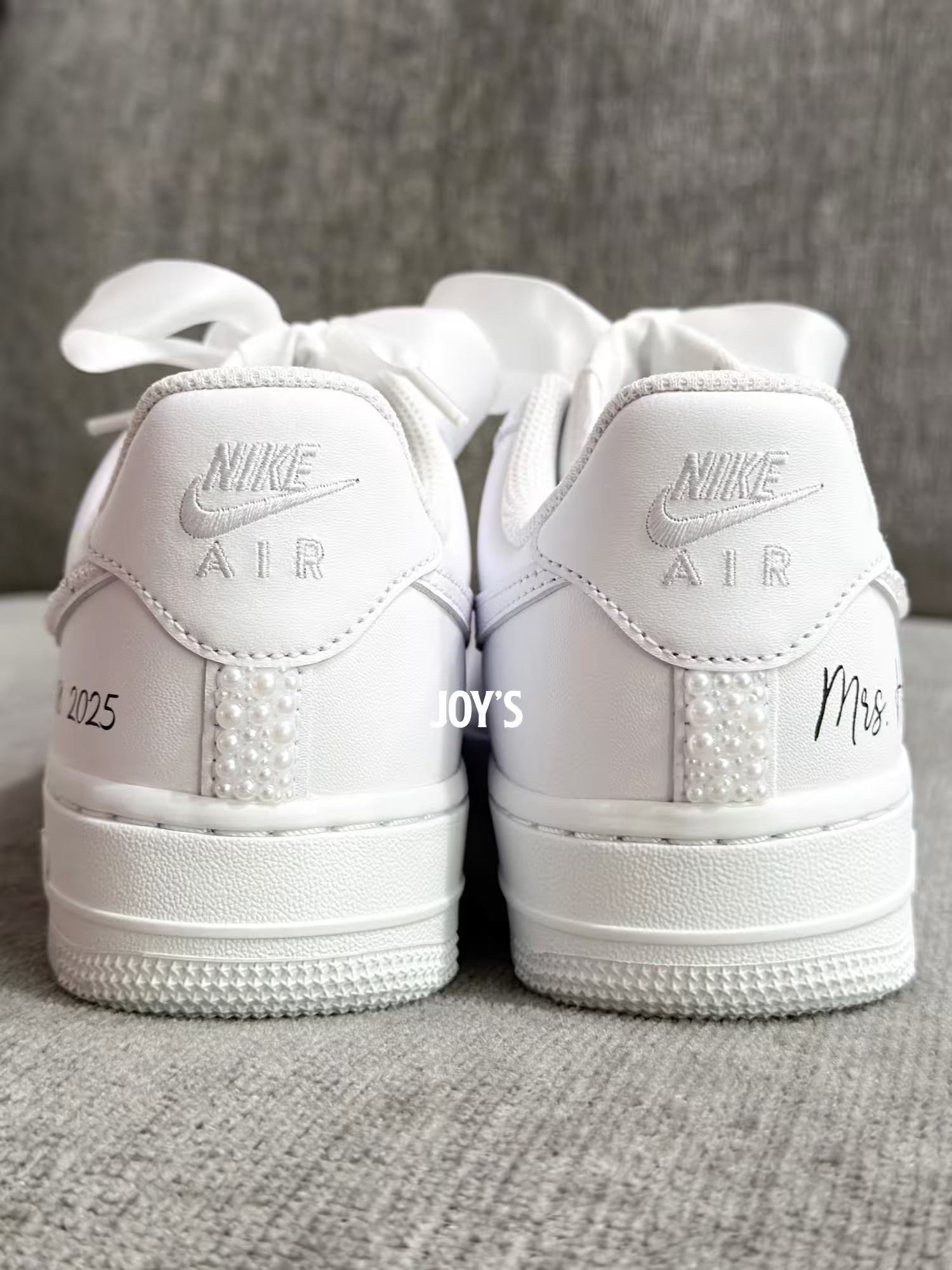 White wedding sneakers embellished with rhinestones, pearls, and subtle bling details