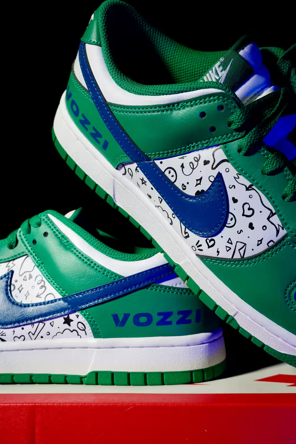 Green and blue Dunk sneakers with white accents on a black background