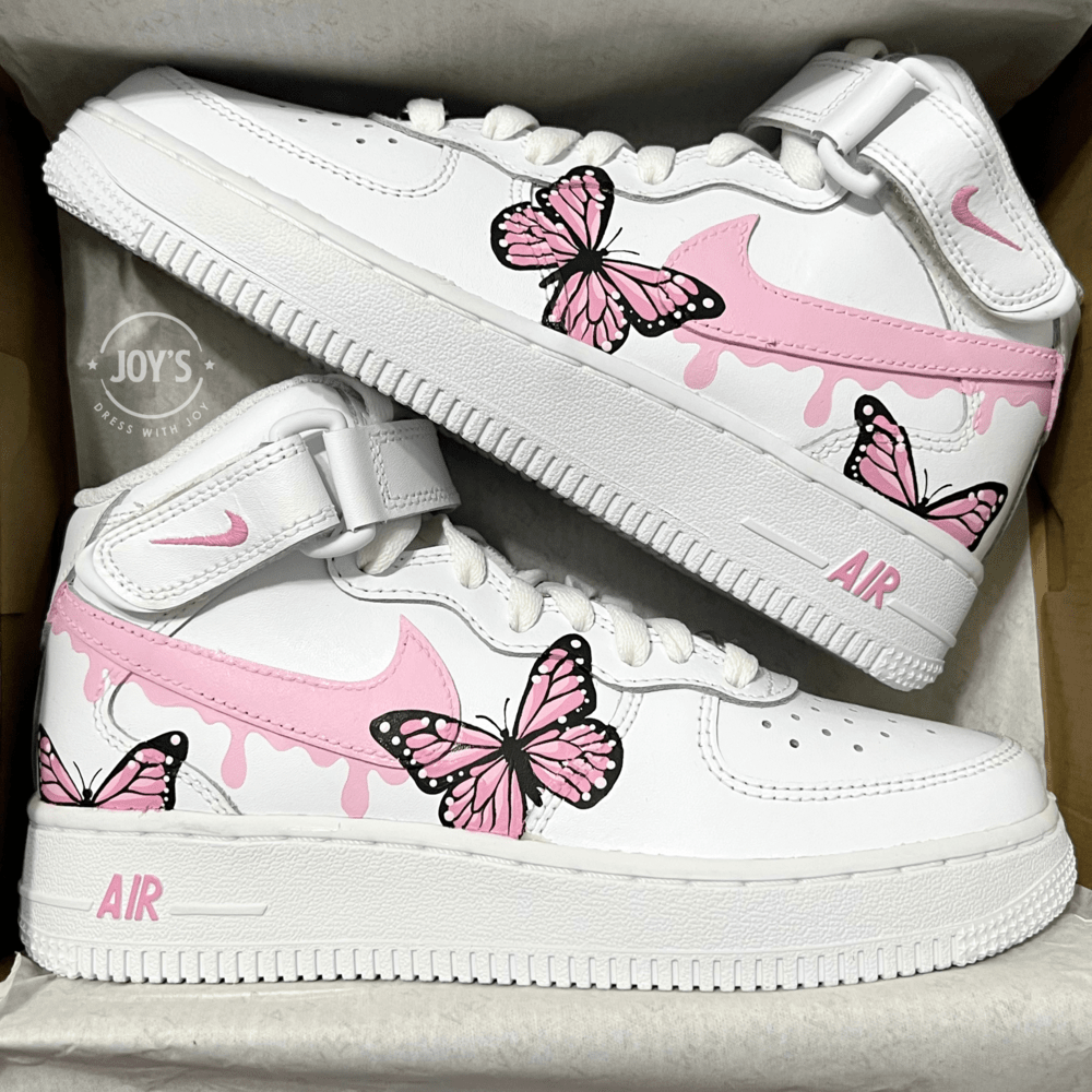 Pink Drip Pair of custom white Nike Air Force 1 sneakers with pink drip swoosh and hand-painted pink butterfly designs, displayed side by side