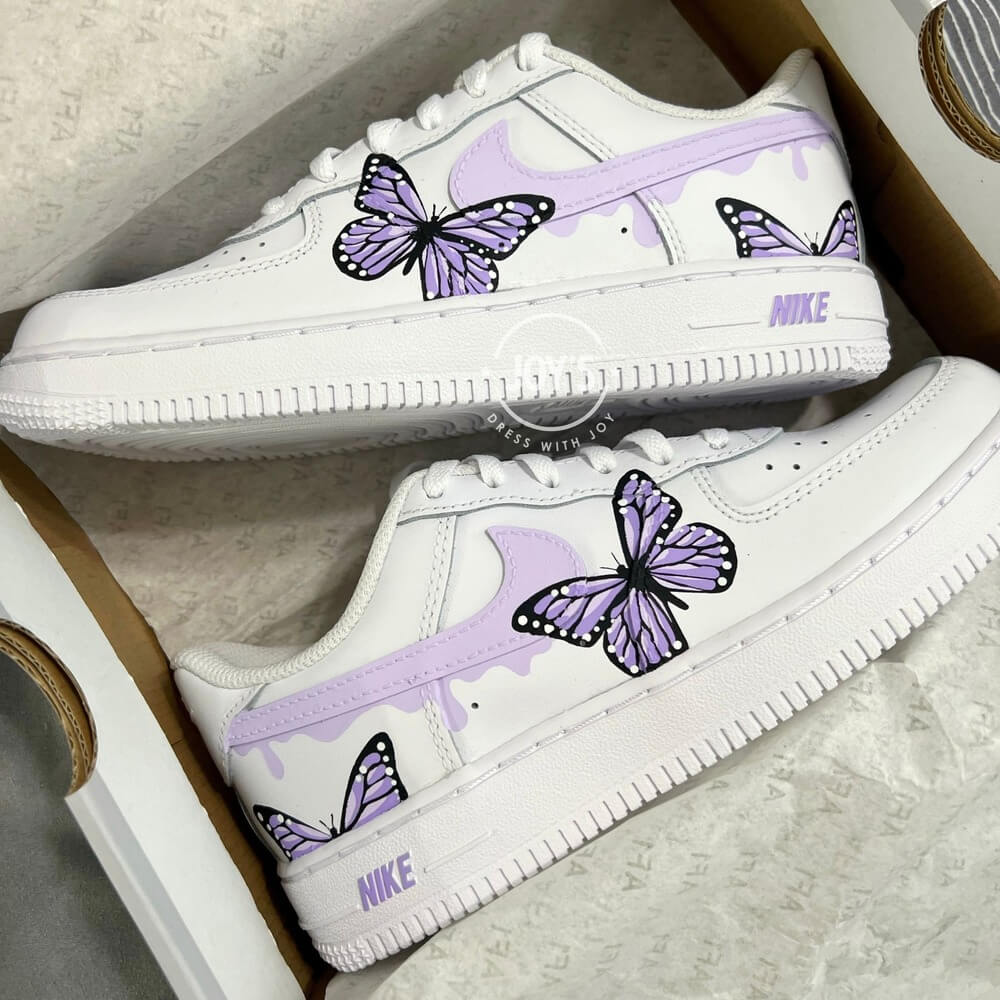 Custom white Nike Air Force 1 sneakers with hand-painted pastel swoosh and butterfly artwork.