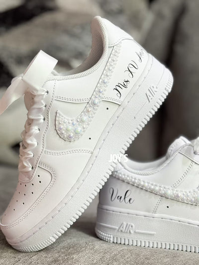 White wedding sneakers embellished with rhinestones, pearls, and subtle bling details