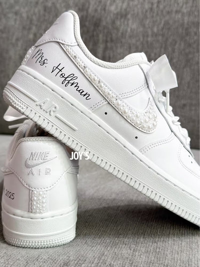 White wedding sneakers embellished with rhinestones, pearls, and subtle bling details