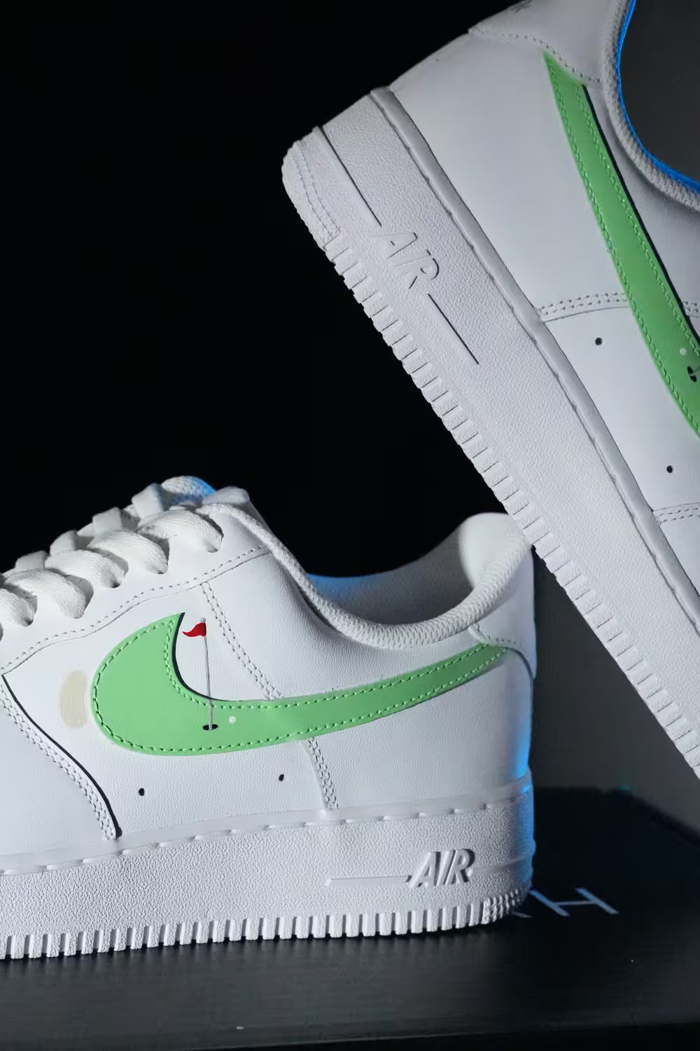 White Custom Golf sneakers with green accents on a black background