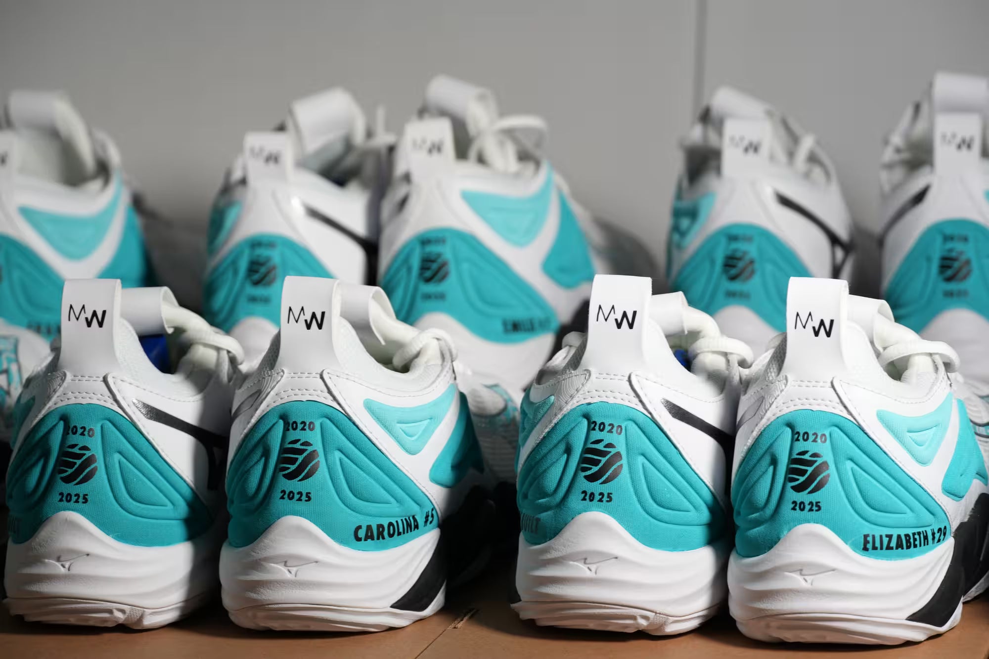 White and turquoise Custom sneakers for Companies with branding on a gray background