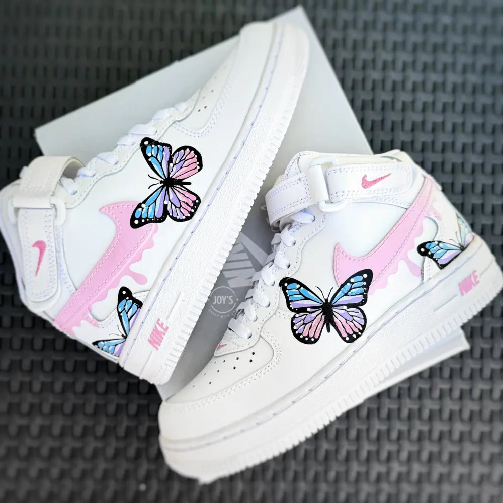 Custom hand-painted Nike Air Force 1 Mid baby sneakers with pastel butterfly artwork and pink details.