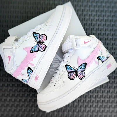 Custom hand-painted Nike Air Force 1 Low sneakers with pastel butterfly artwork and pink swoosh details.