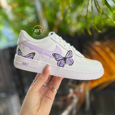 Custom white Nike Air Force 1 sneakers with hand-painted pastel swoosh and butterfly artwork.