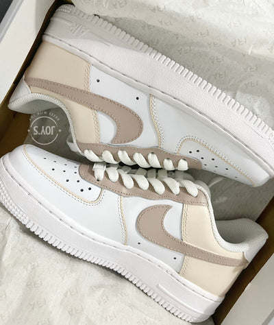 White Nike Air Force 1 Low with beige and cream color block panels.